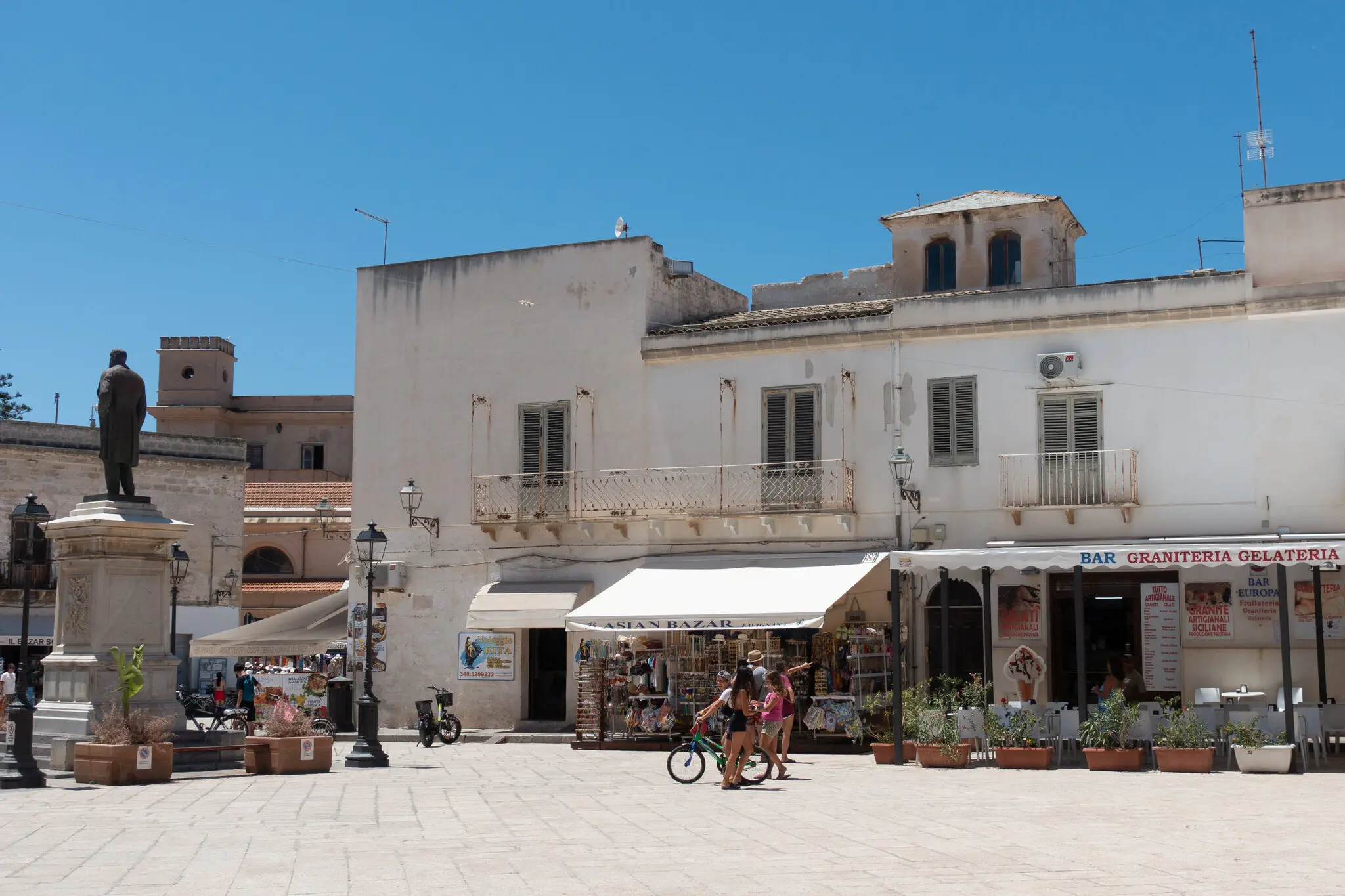 У головному місті Фавіньяни вуличні закусочні та пункти прокату велосипедів займають низькі будівлі, збудовані з білого каменю, який місцеві жителі називають туфо.